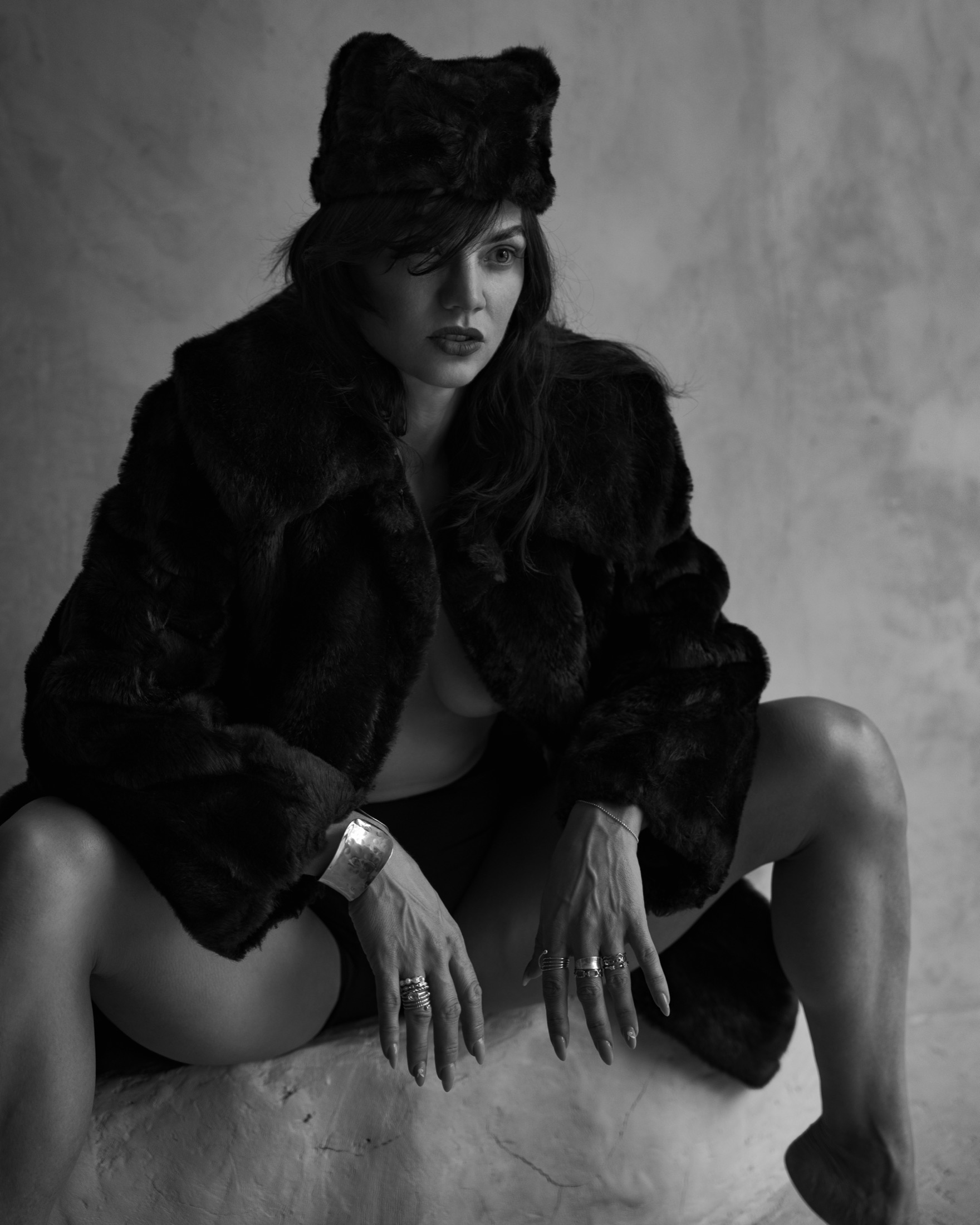Alisa Pleskova in a black fur coat and hat, looking straight at the camera, black and white portrait